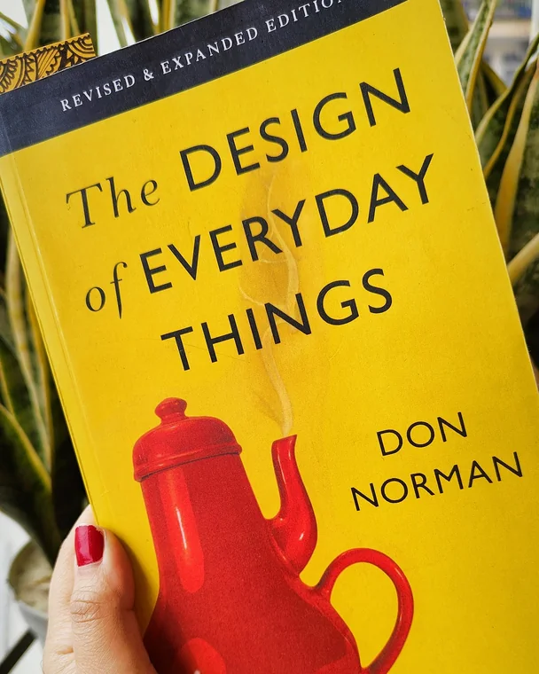 Maryam holding a copy of Don Norman&rsquo;s The Design of Everyday Things.