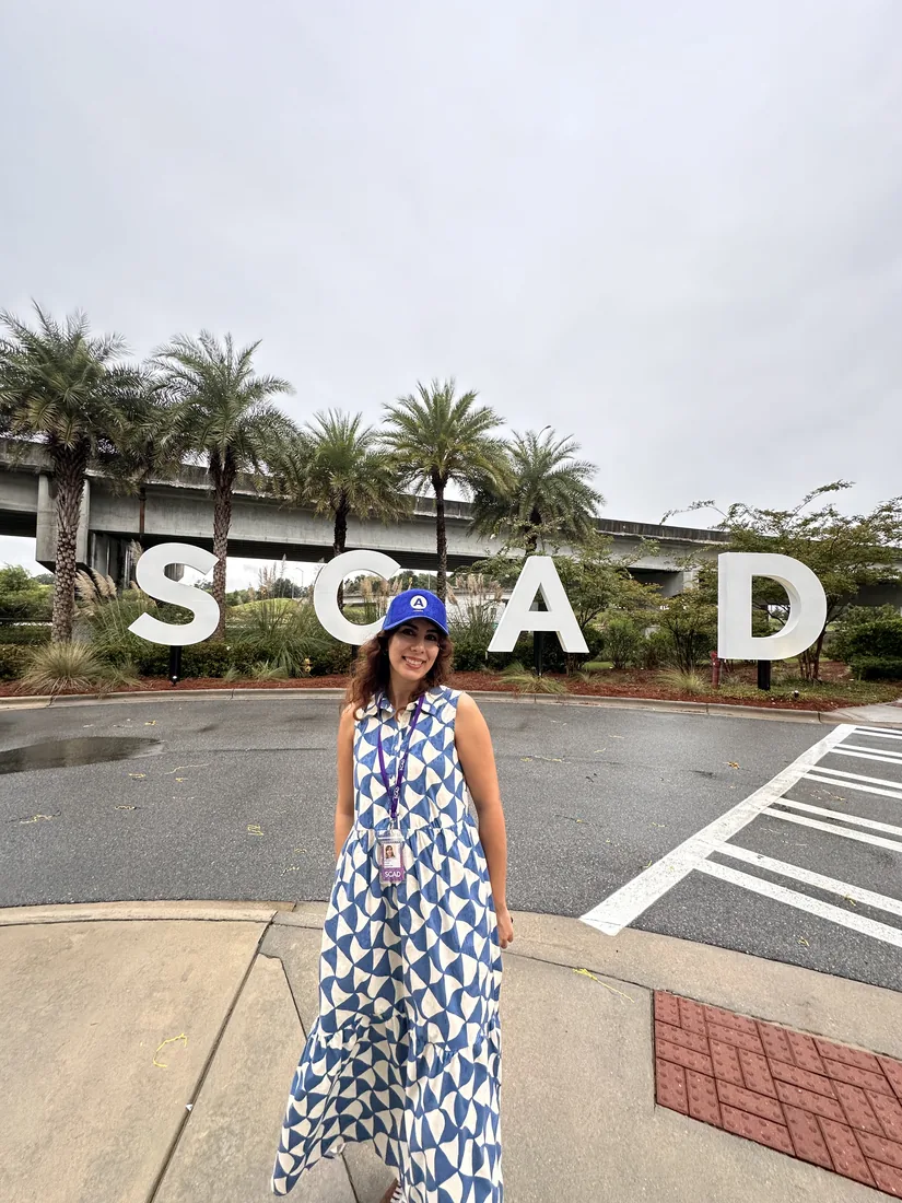 Maryam standing in front of the SCAD sign in Savannah.